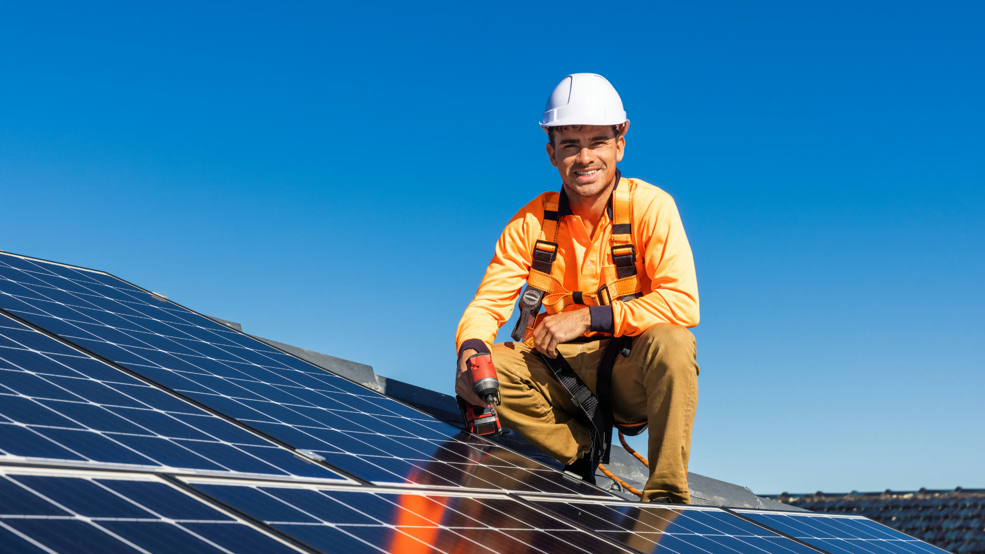 Accredited solar installer on a rooftop
